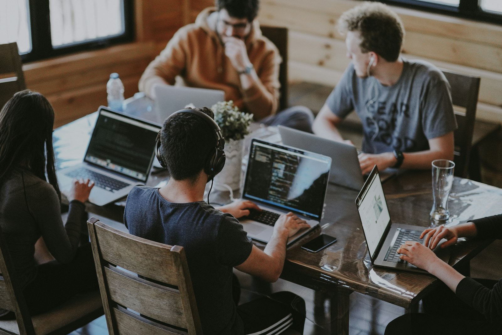 A small cohort of finance professionals working on laptops during an AI budget management course
